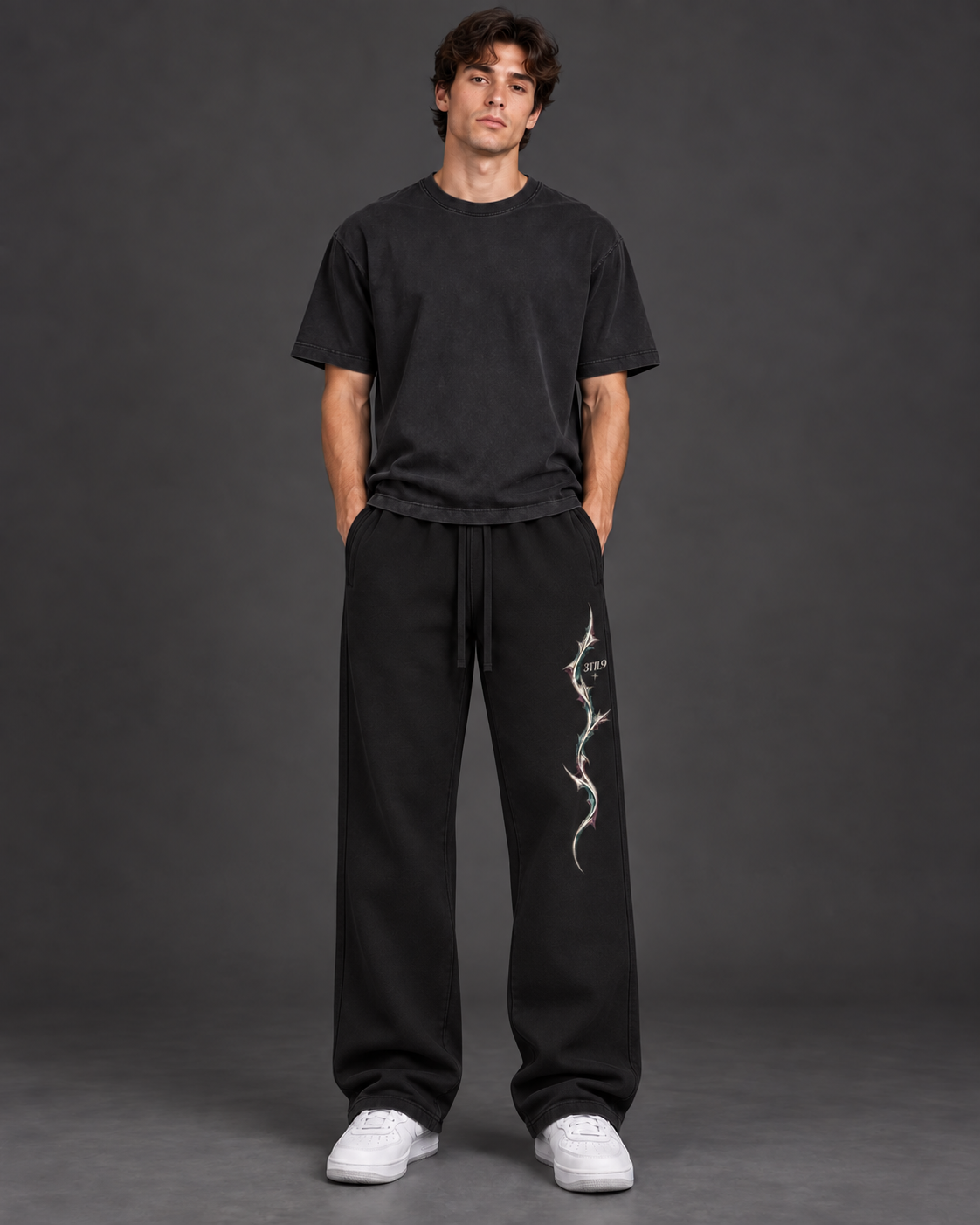Ash Trace - the original model wearing Black relaxed sweatpants with the raised left-leg print, digital preview