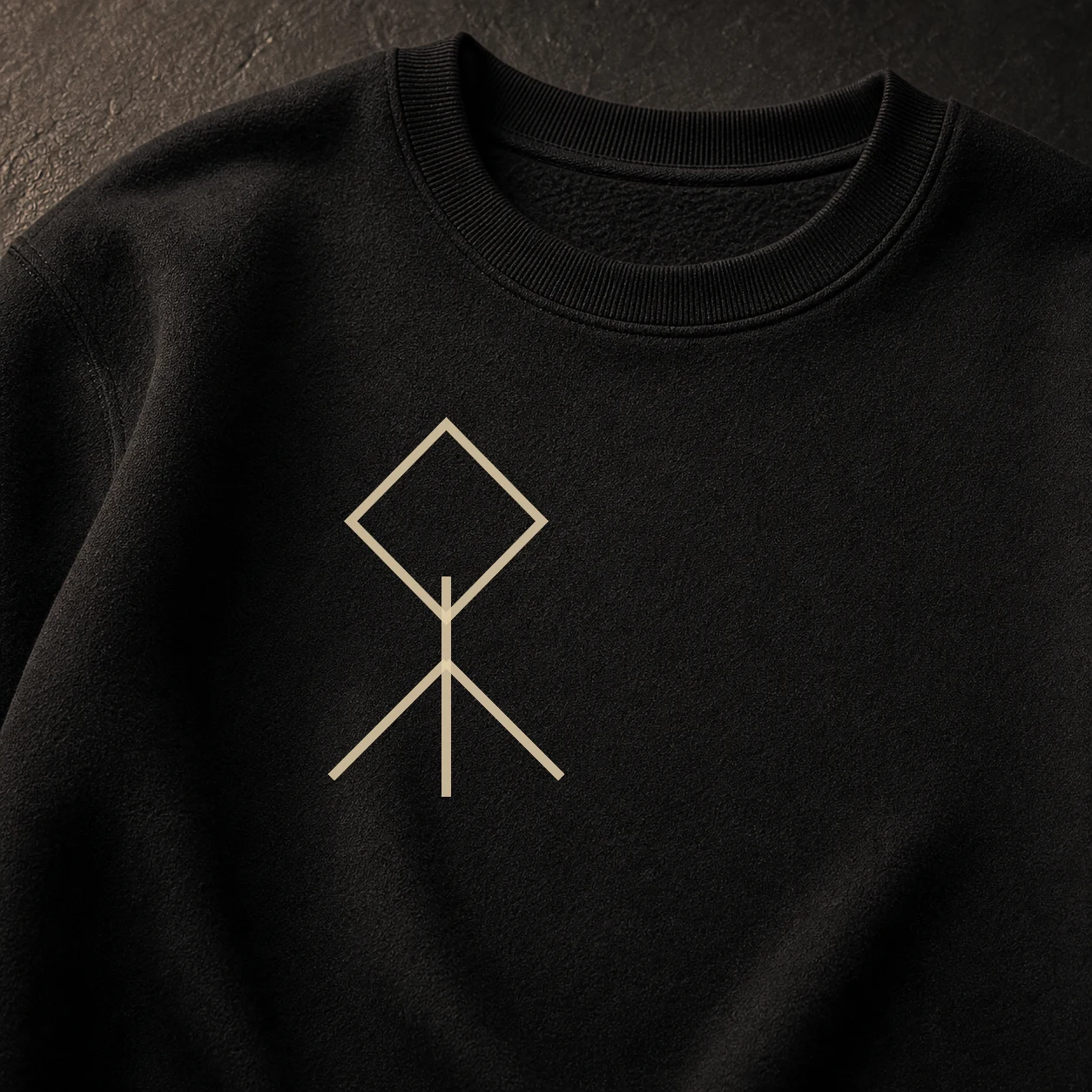 Close view of the Branches sigil embroidery over dense black crewneck fleece.