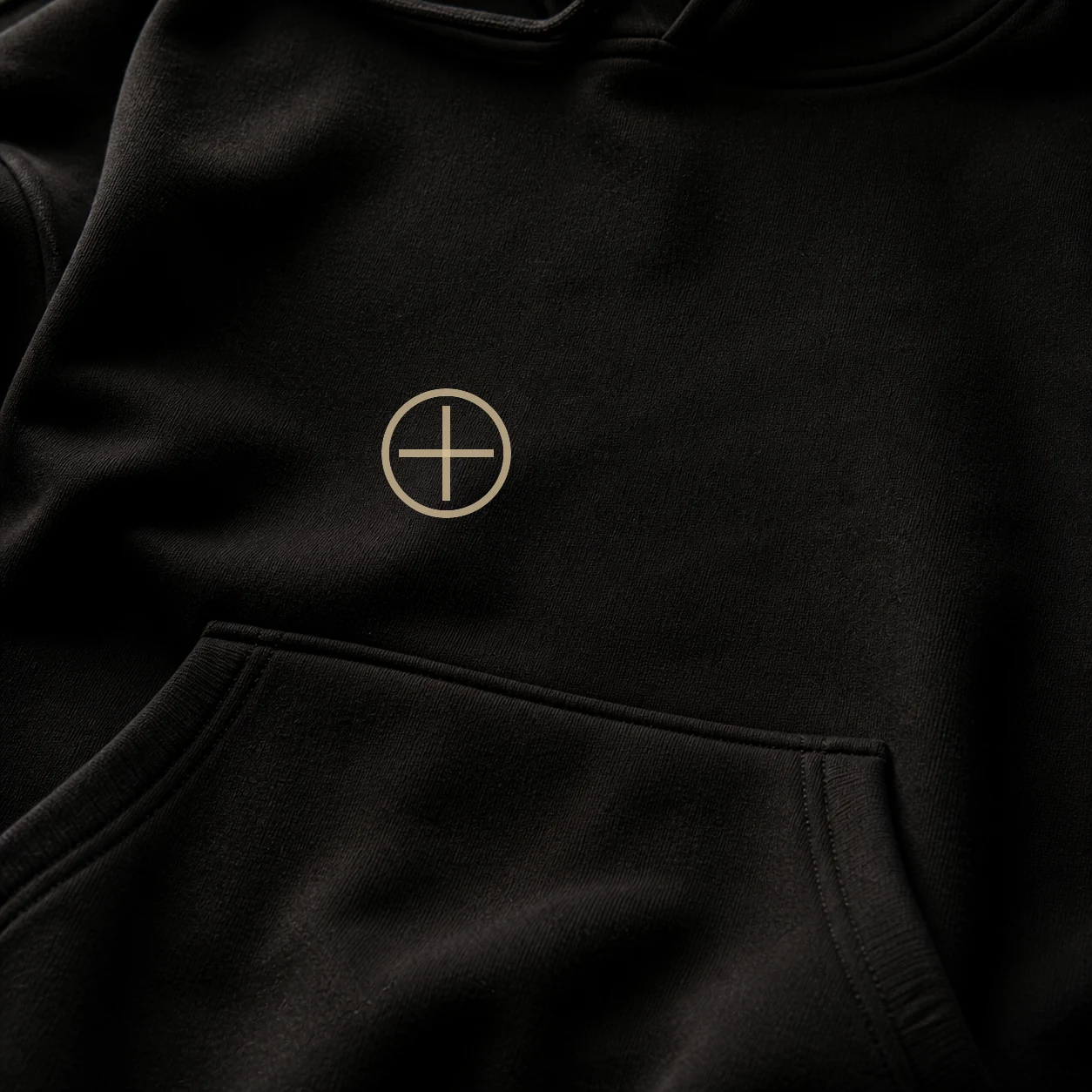 Close view of the EU Spectre hoodie chest insignia on heavy black fleece.