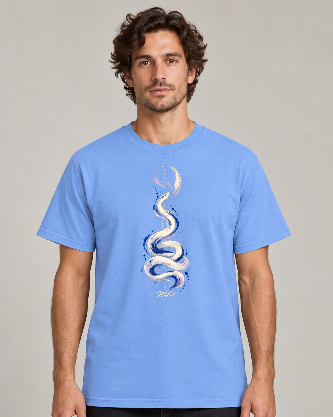 Phase Drift - Carolina Blue cotton T-shirt with the original serpent artwork and canonical cursive 3til9 footer; same-model digital wearing view.